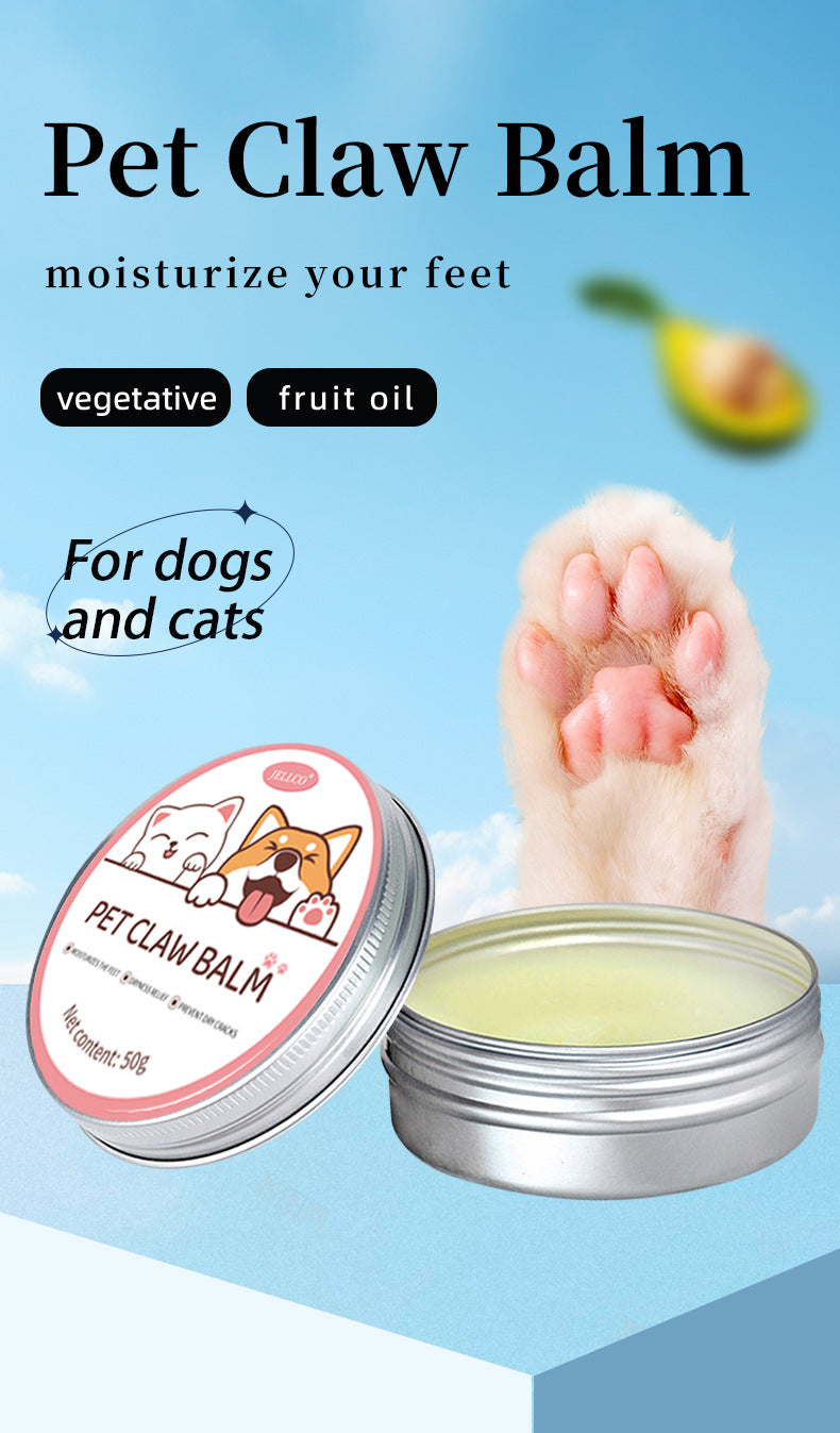 Pet claw balm tin beside dog paw pads, with pale yellow balm visible