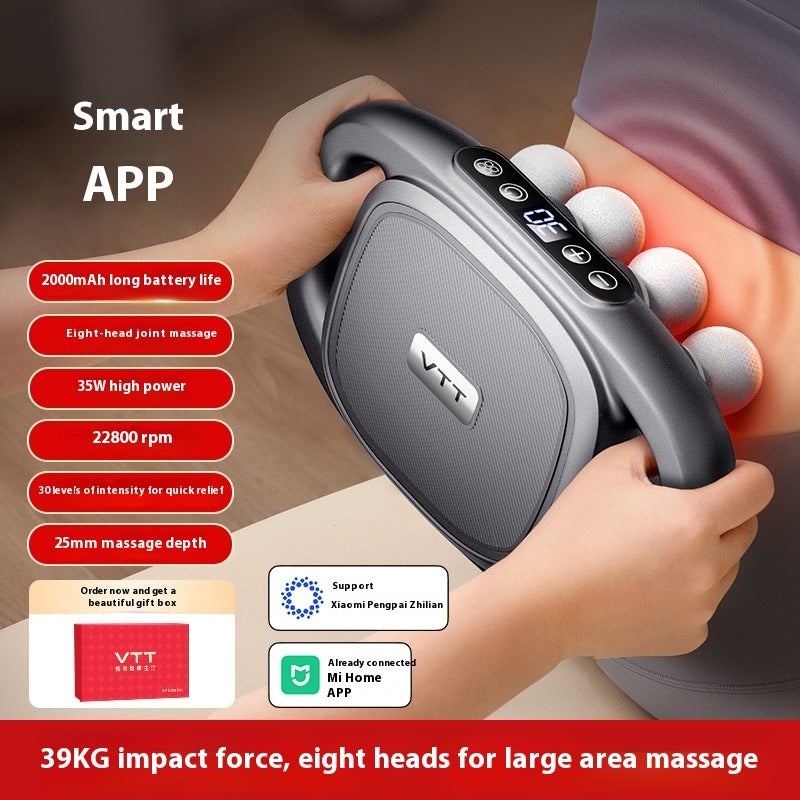 Gray massage gun with round head tips and control buttons, held in a hand