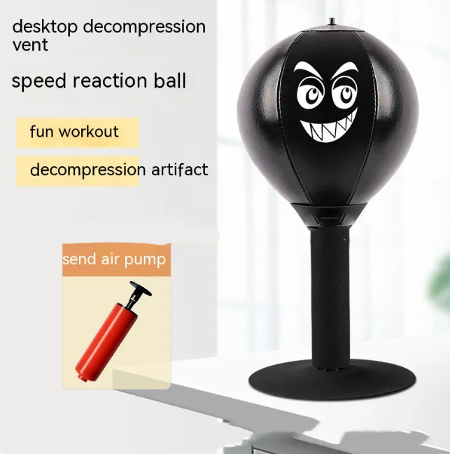 Black desktop punching reflex speed ball with cartoon face on tall black stand