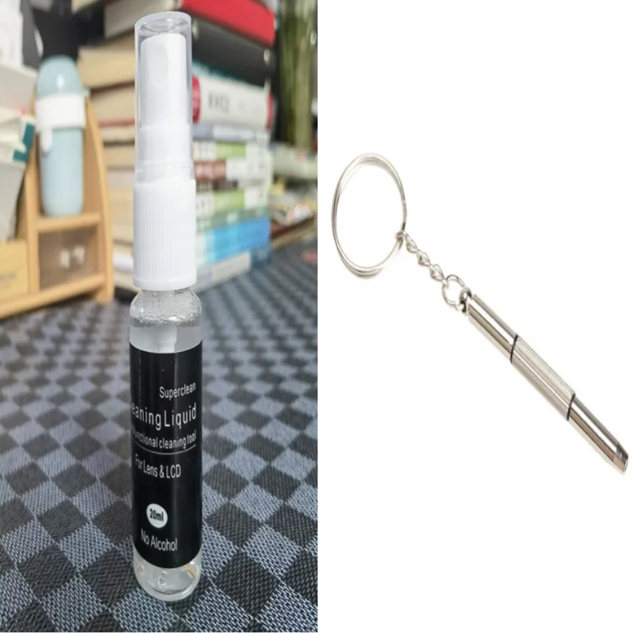 Camera lens cleaner spray with white nozzle and metal keychain cleaning tool