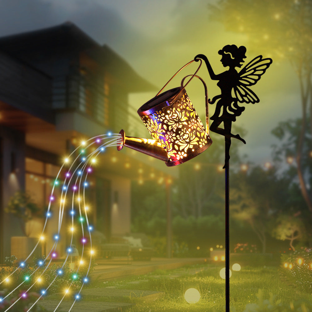Solar fairy lawn lamp with black stake, glowing floral lantern projection and angel silhouette