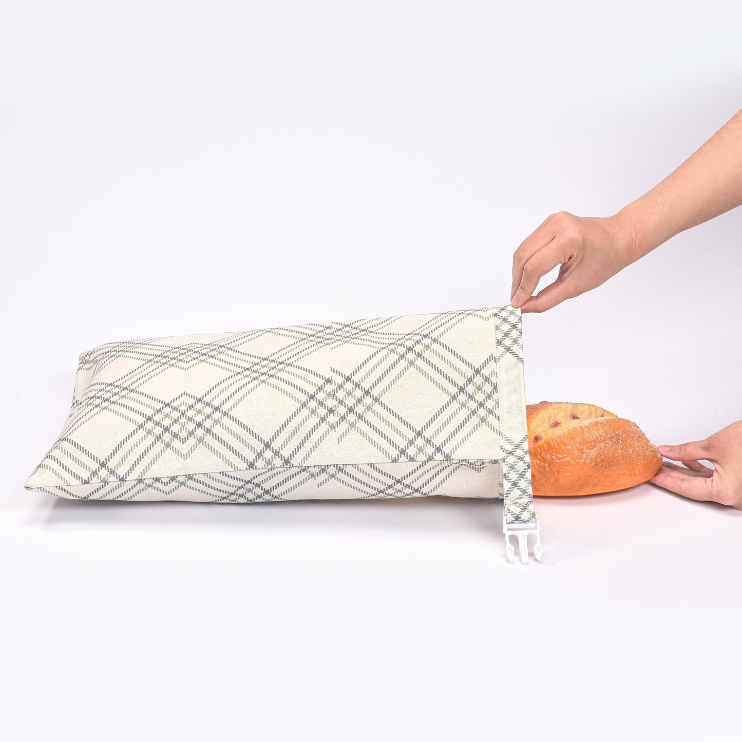 Cotton linen bread storage bag with dark plaid pattern and drawstring ties, folded open.