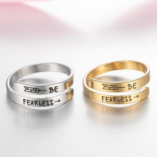 Engraved double ring set: silver and gold bands with "BE" and "FEARLESS" text
