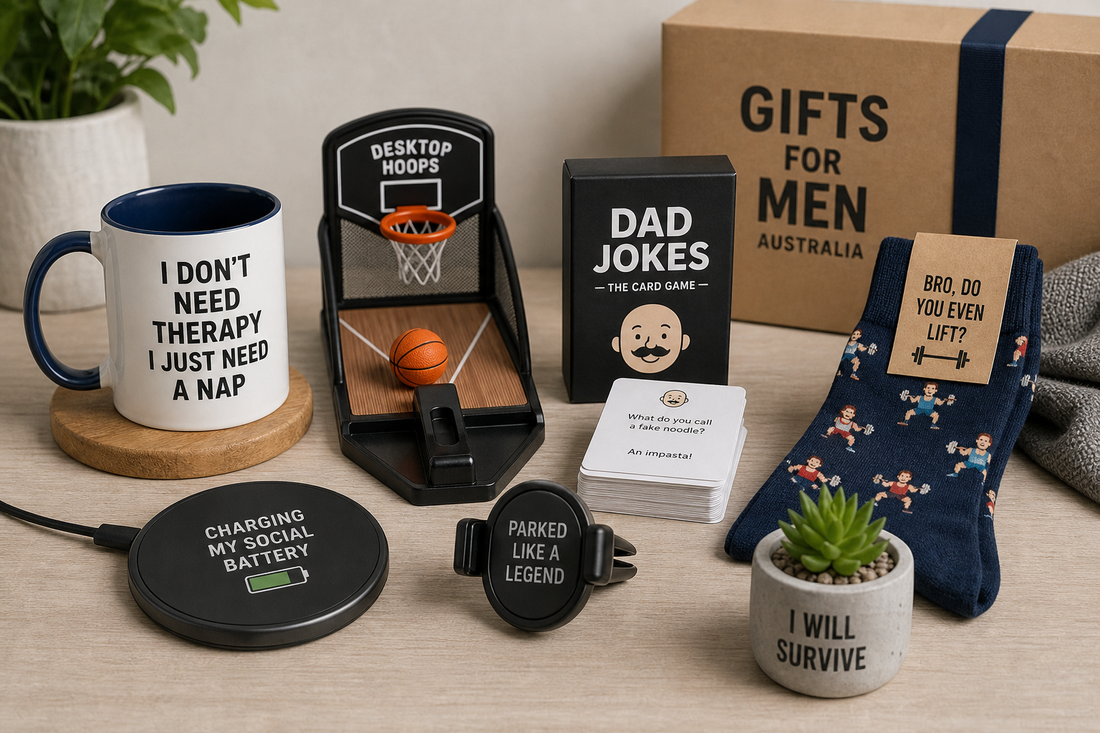 A selection of novelty gifts for men including a mug, desk game, card game, socks, charger, car accessory, and decor item on a tabletop.