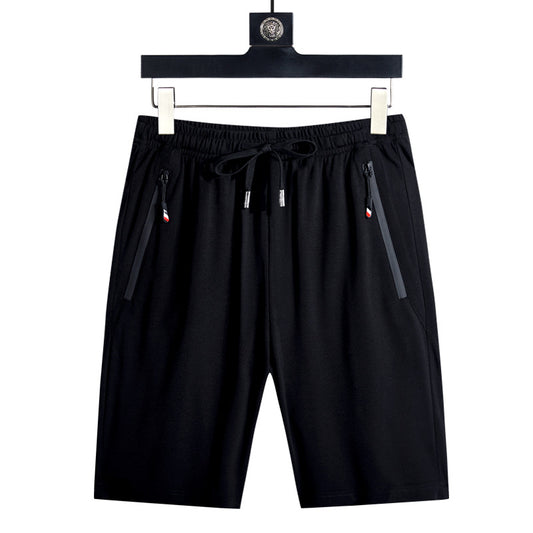Black athletic swim shorts with elastic waistband, drawstring, and zip side pockets