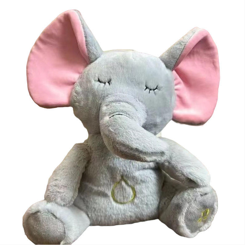 Grey elephant plush music toy with pink inner ears and glowing belly heart
