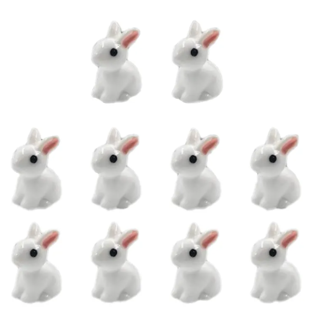 Pack of small white rabbit resin figurines with red ears and black eyes, seated poses.