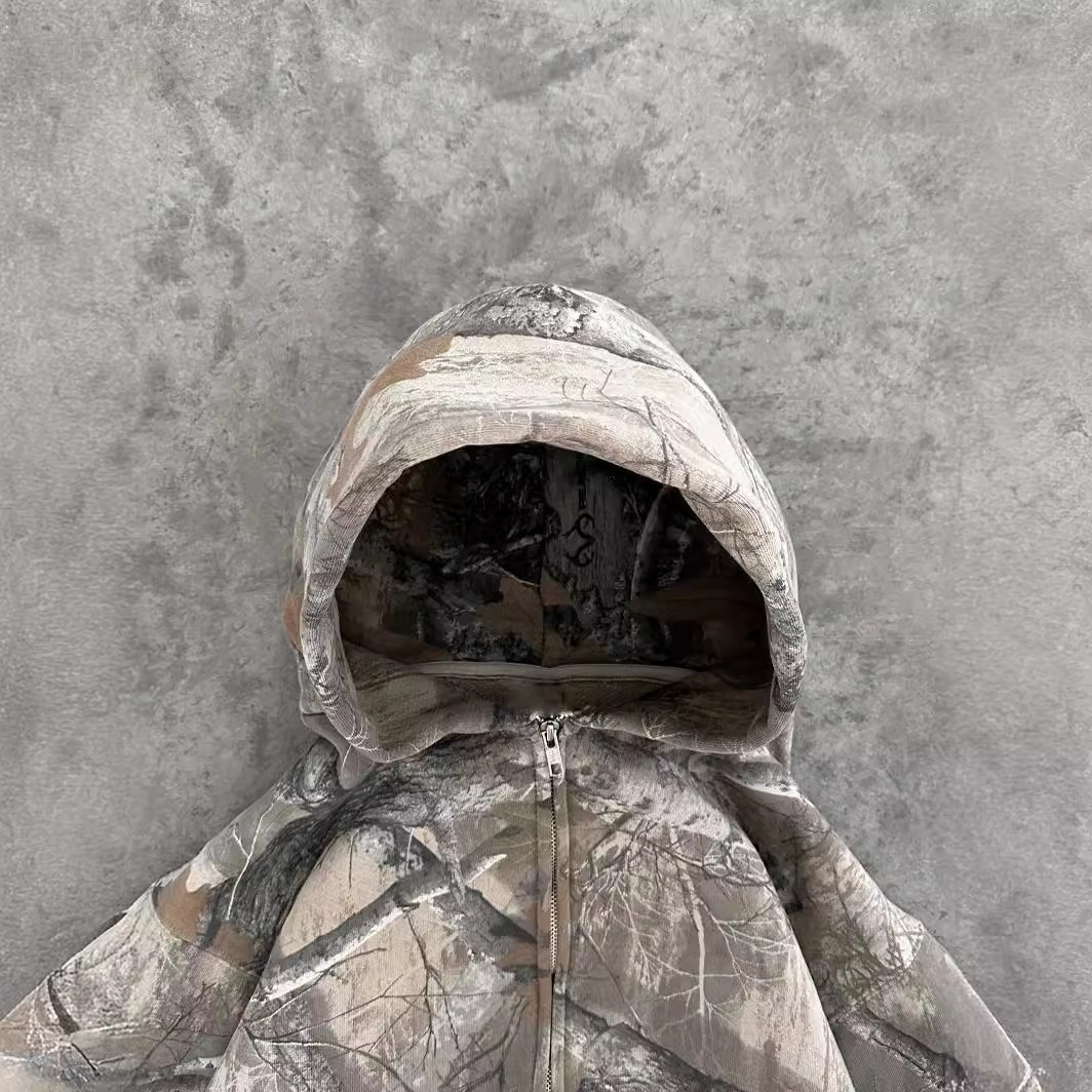 Camouflage zip-up hoodie hood with drawstring, visible front zipper, long sleeves