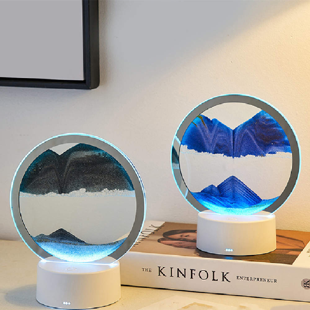 Quicksand night lamp with circular glass top and white base, blue sand glow