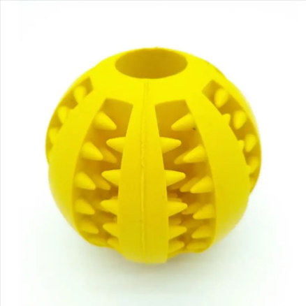 Yellow rubber treat-dispensing slow feeder dog ball with central divider and spike ridges