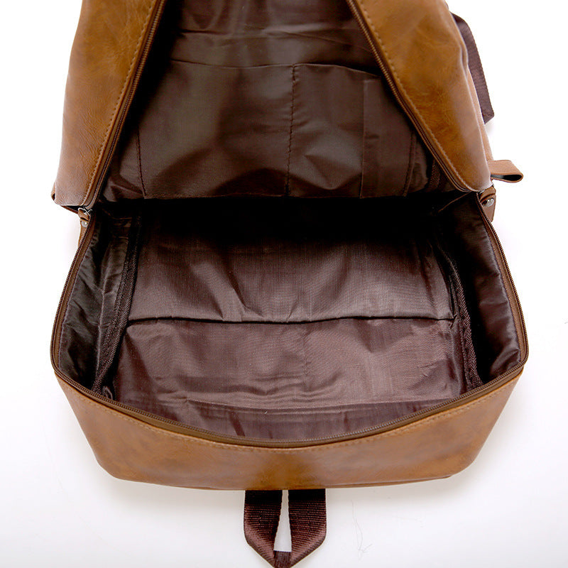 Brown PU leather backpack interior with padded lining and multiple compartments