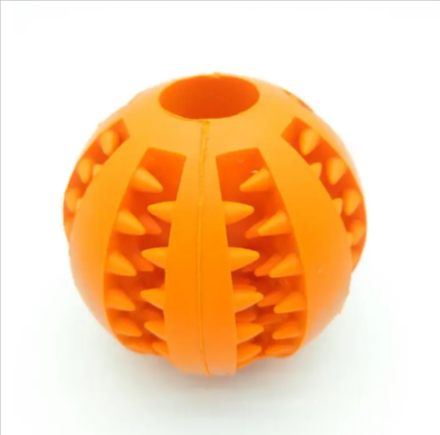 Orange rubber treat-dispensing puzzle dog ball with ridged patterns