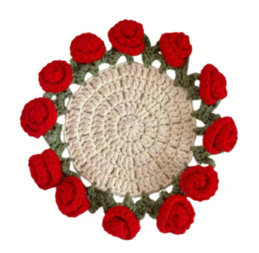 Crochet coaster with cream round center, red rose flowers, and green leaf edging
