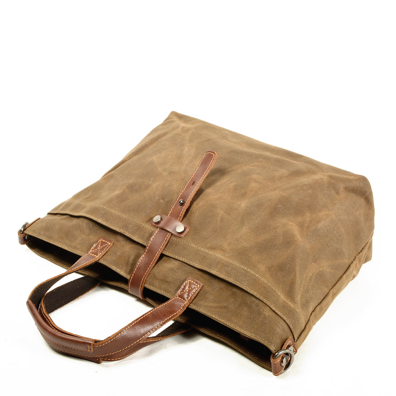 Large canvas tote bag with leather handles and front pocket flap, shown tilted