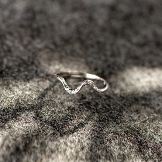 Silver open adjustable ring with wavy geometric top and small clear stone accents