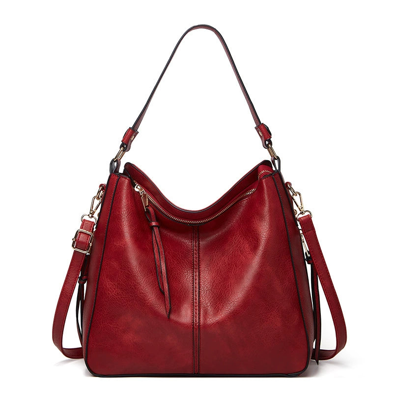 Red PU leather crossbody bag with top handles and front zip pocket