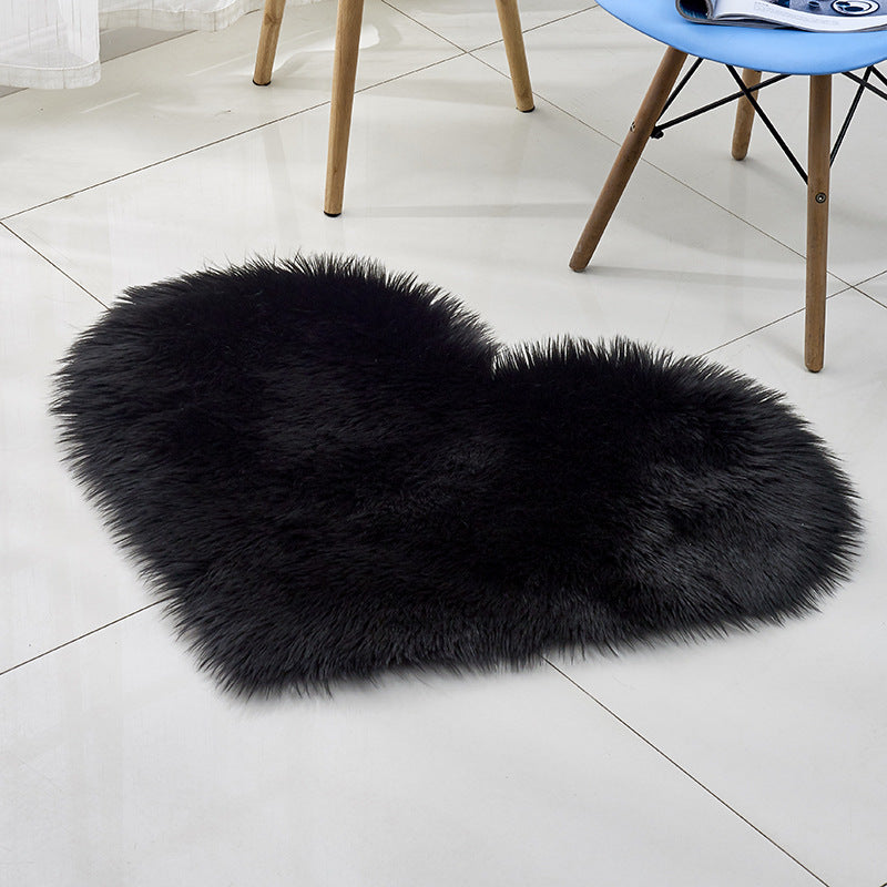 Plush heart-shaped rug, black, long-pile shag texture in heart silhouette