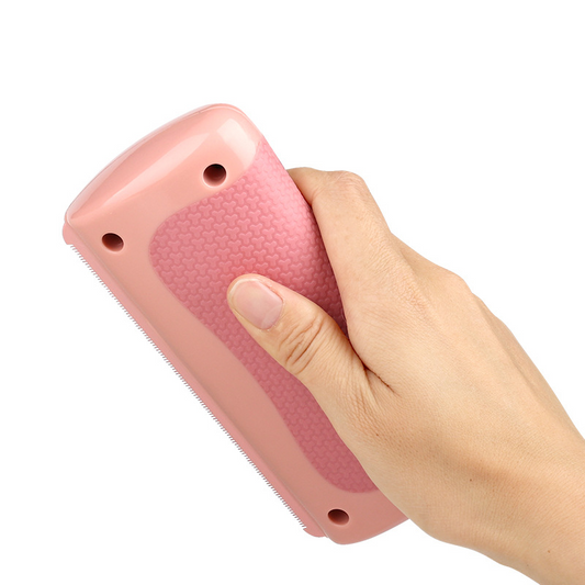 Pink pet grooming comb with dual-sided teeth and finger-grip handle holes