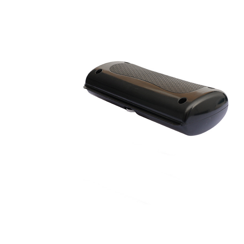 Black grooming comb with dual-tooth edges and textured grip on the center panel