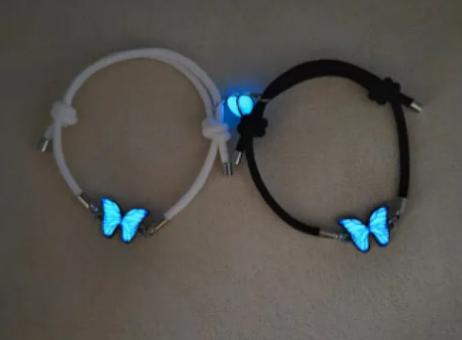 Glow butterfly charm bracelets, one white and one black cord