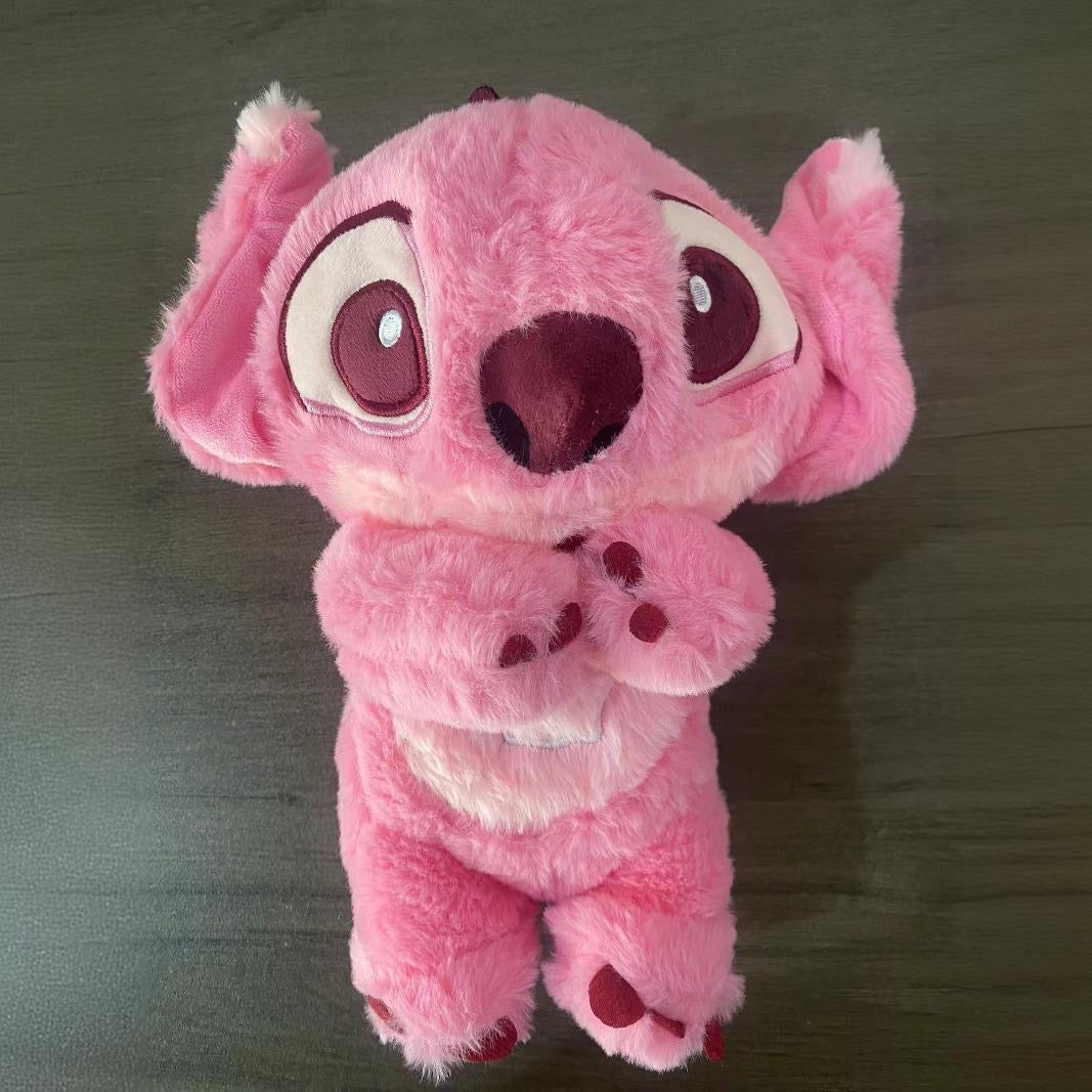 Pink plush baby sound machine, large ears and heart-patterned belly detail.