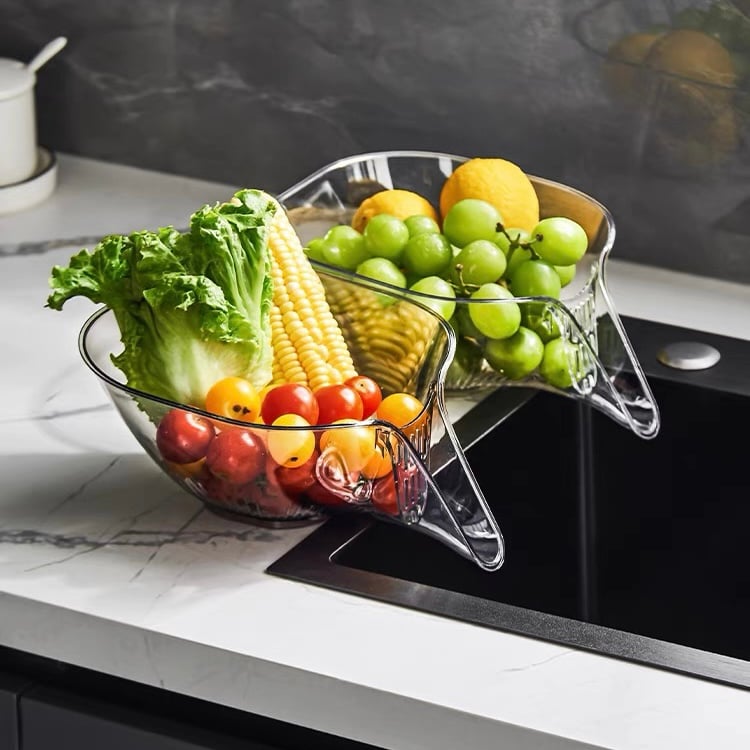 Transparent PCTG drain basket colander with perforated bowl, holding assorted vegetables