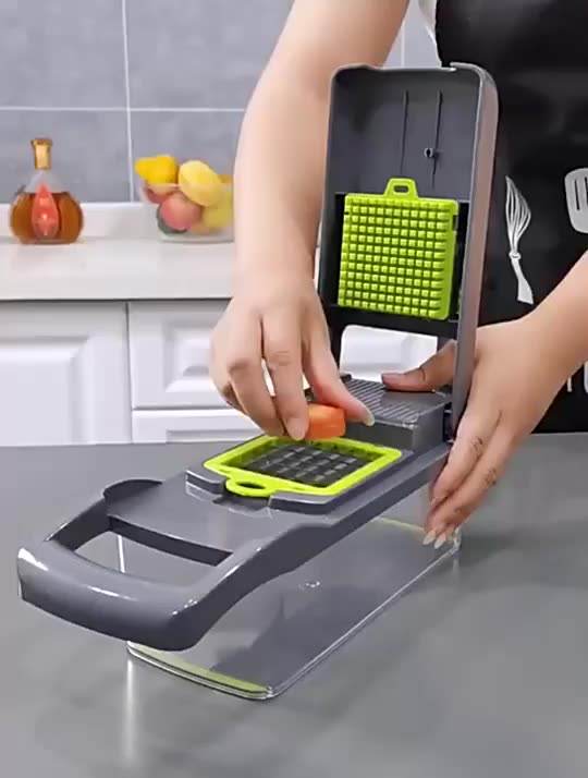 Vegetable chopper and dicer with green perforated grater insert in use