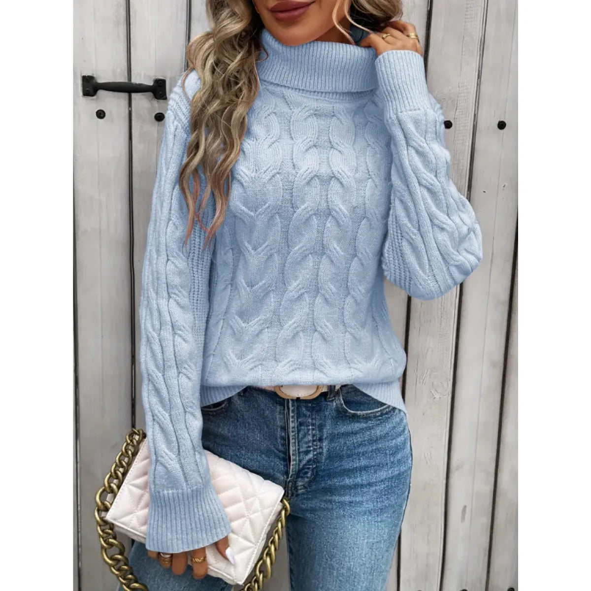 Light blue cable-knit turtleneck sweater with raised cable waves