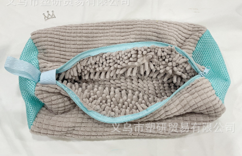 Gray mesh shoe laundry bag with blue trim and zipper, filled with gray foam beads