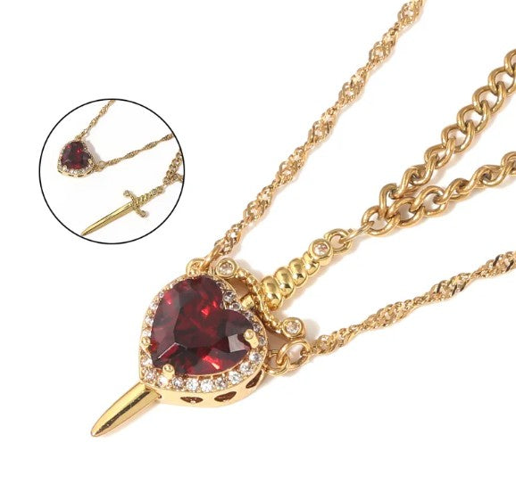 Heart and dagger pendant necklace with red crystal, gold-tone chain and link detail