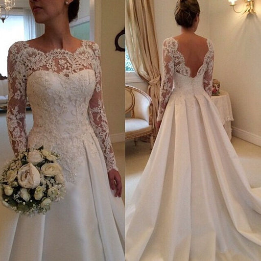 Ivory lace long-sleeve wedding dress with fitted bodice and full skirt, vintage train
