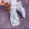 Light blue reflexology socks with detailed foot acupressure diagram, close-up