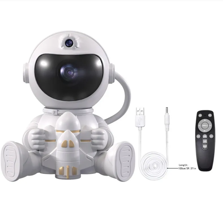 White astronaut night light projector lamp with USB cable and black remote.