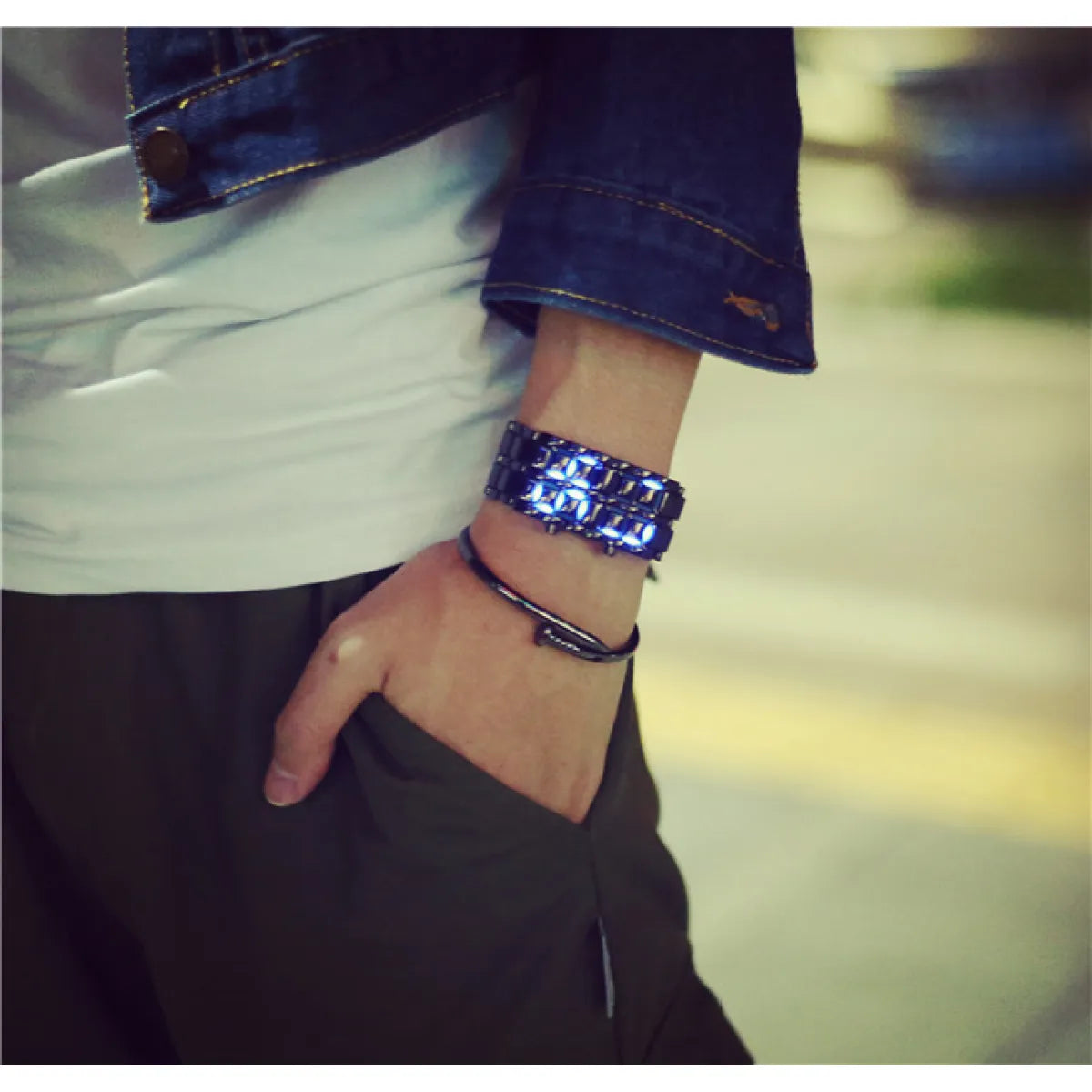Unisex LED electronic watch with blue illuminated lava-style display on dark strap