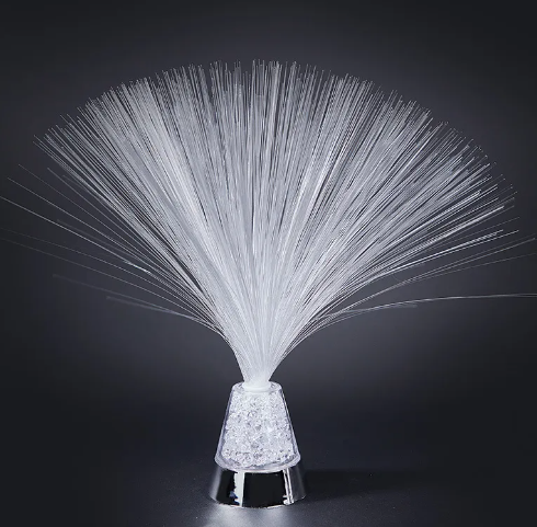 Fiber optic colour-changing lamp with white fiber strands and textured clear crystal base