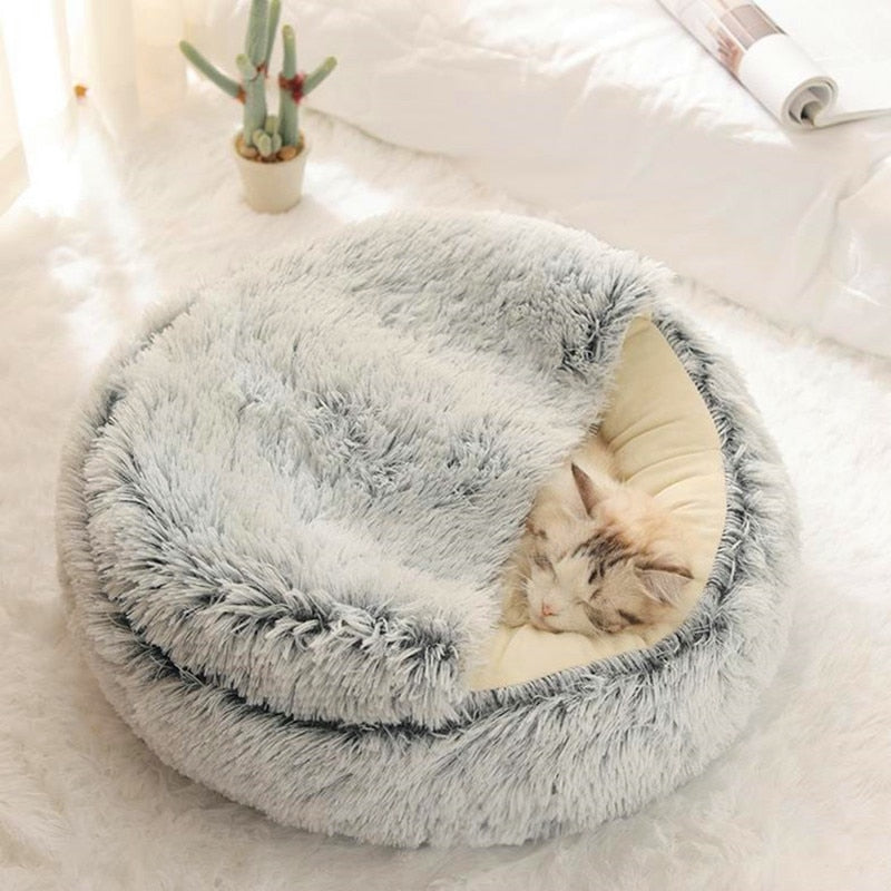 Gray plush pet bed with raised rim and tunnel entrance, cat sleeping inside
