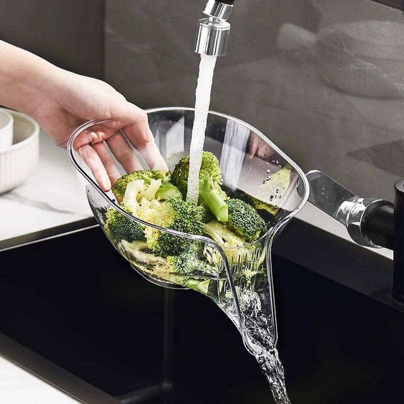 Transparent PCTG drain basket colander under running water, with side handle grips