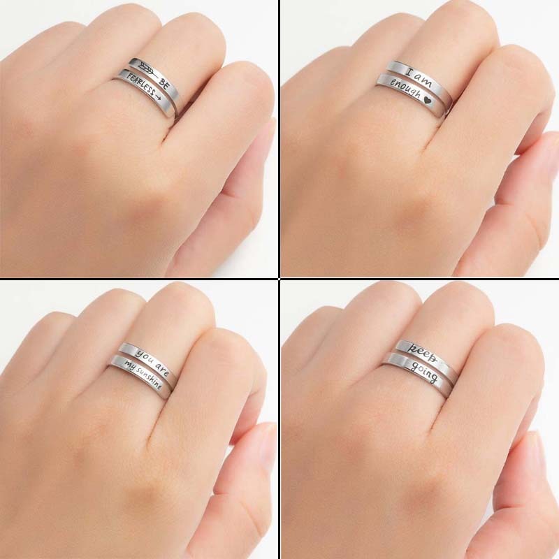 Engraved double ring on finger, silver and gold bands with motivational text