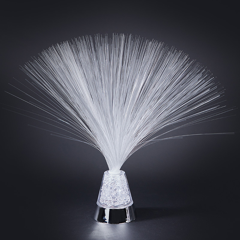 Fiber optic colour-changing lamp with white fiber strands and clear crystal-tinted base