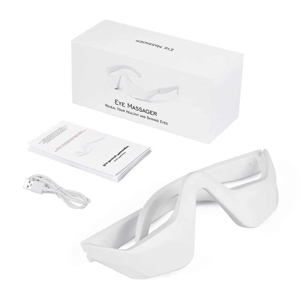 White eye massager kit with box, booklet, and USB cable