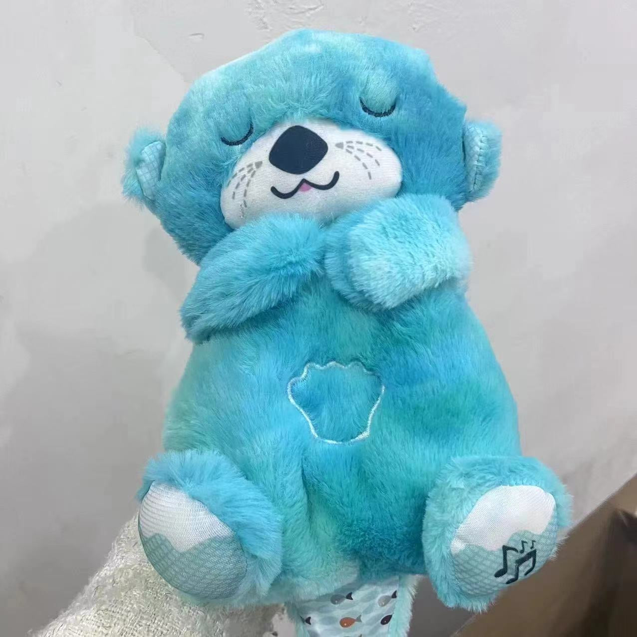 Blue plush otter baby sound machine, seated pose with closed eyes and teal details