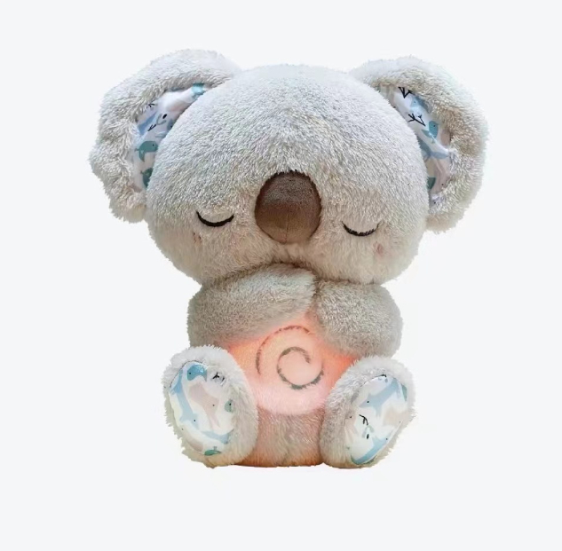 Light grey lamb plush music toy with closed eyes and glowing belly