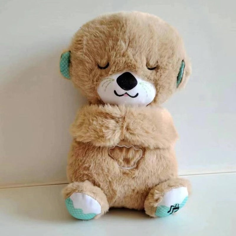 Brown plush baby sound machine animal with closed eyes and musical paw patch