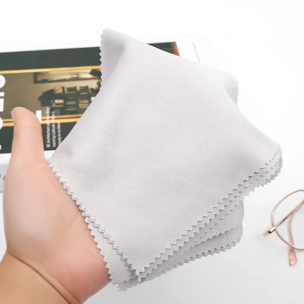 Microfiber cleaning cloth, white square cloth with serrated edge held in hand