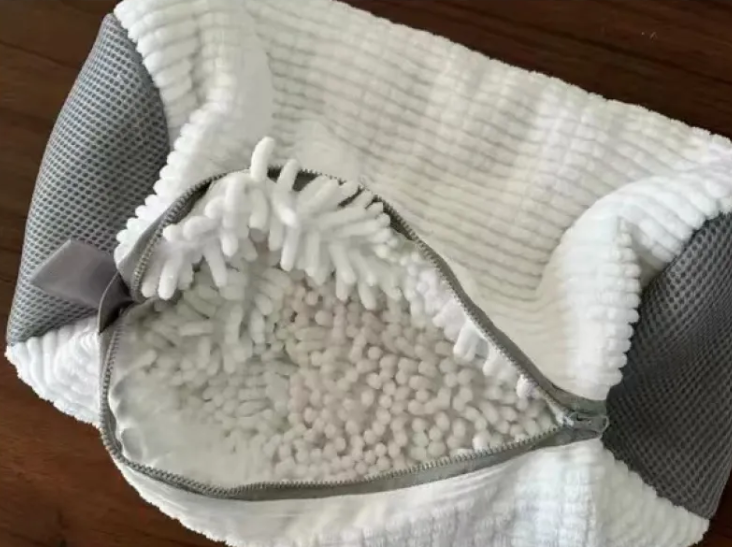 White and gray mesh shoe laundry bag with zipper open, sneakers inside