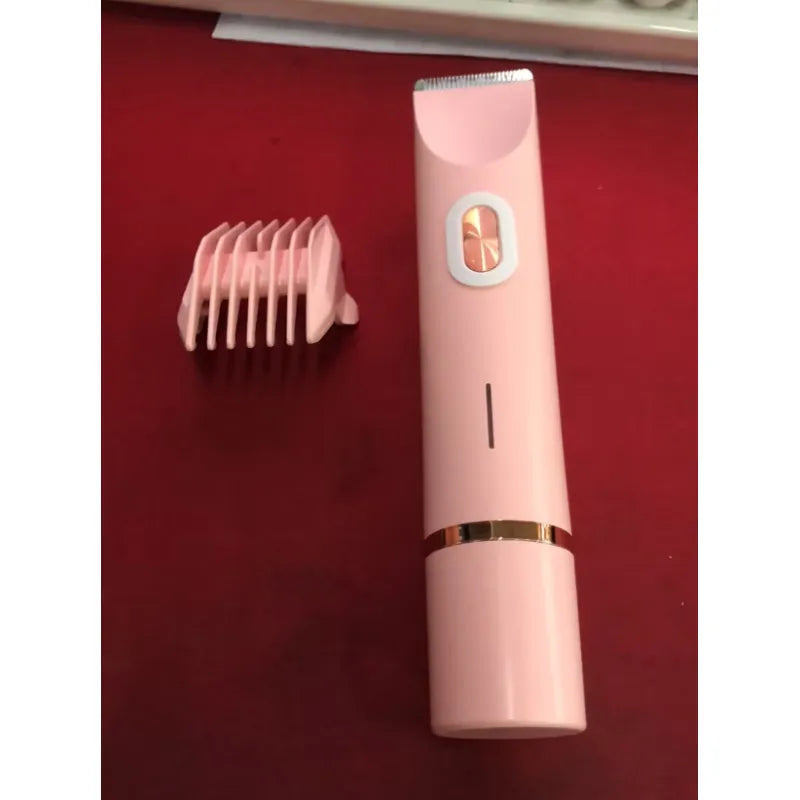 Pink electric hair remover shaver with comb attachment and power button detail.