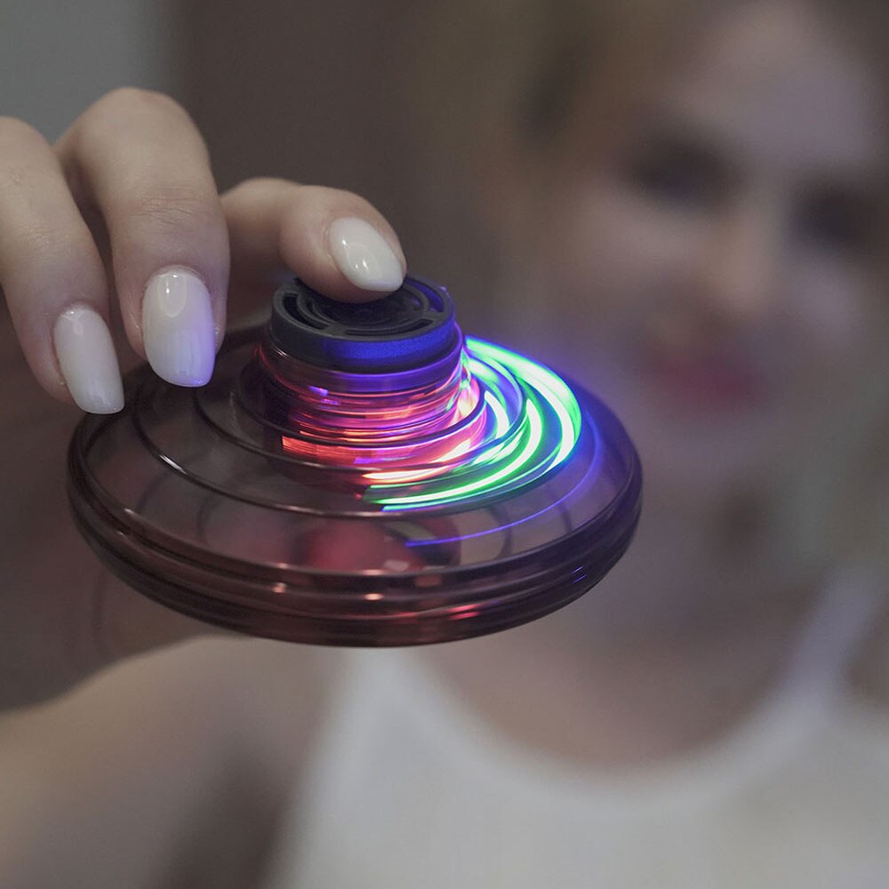 Mini UFO spinner with hand holding top, multicolor LED light ring