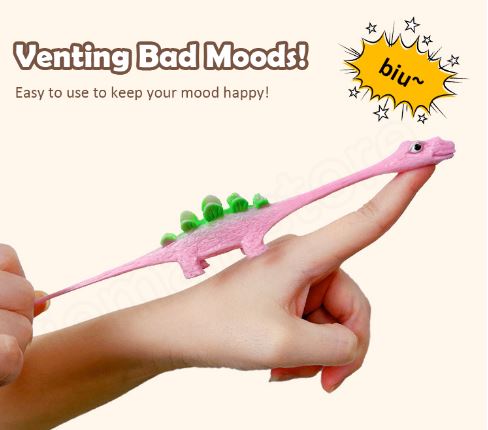 Pink dinosaur slingshot finger toy with green back spikes held in hand