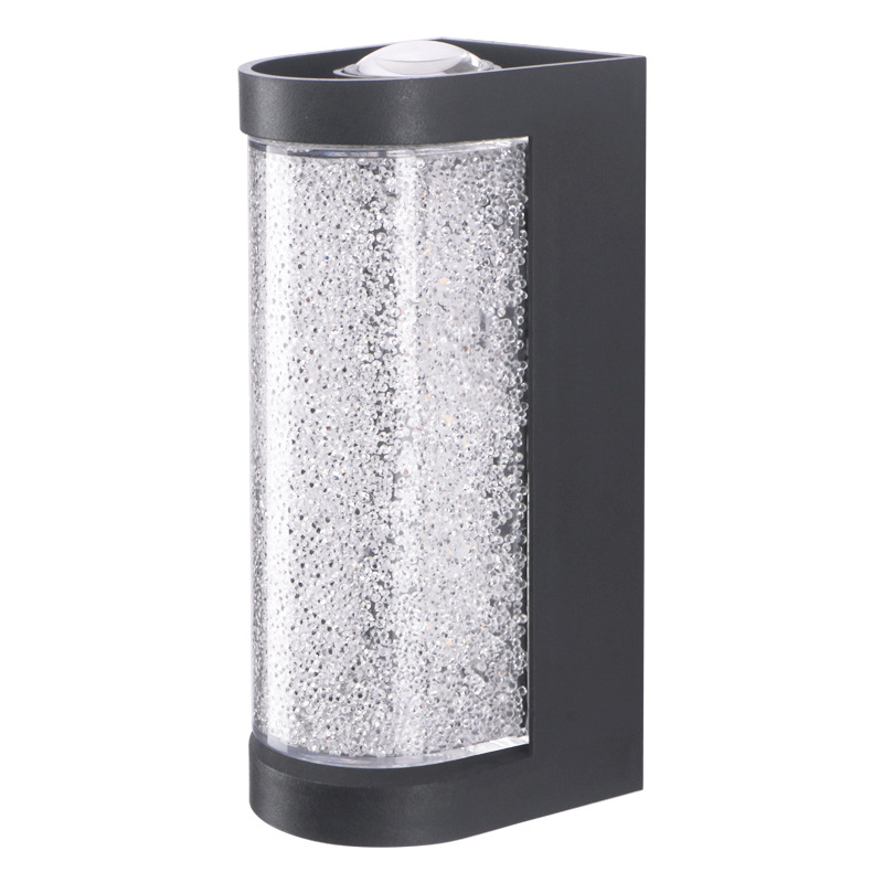 Square LED wall sconce with speckled clear glass cylinder and black bezel, close-up