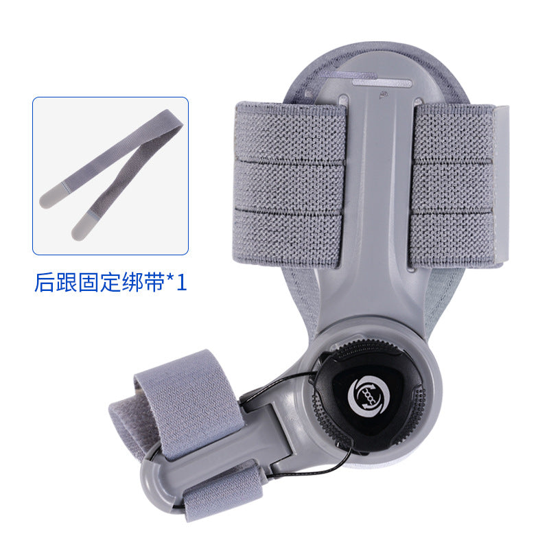 Gray bunion corrector brace with toe separator strap and circular traction adjustment knob